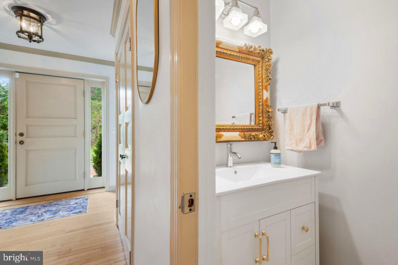 1803 Thornton Ridge Road Baltimore, MD 21204 - Photo 34 of 81 a bathroom with a sink a mirror and a shower