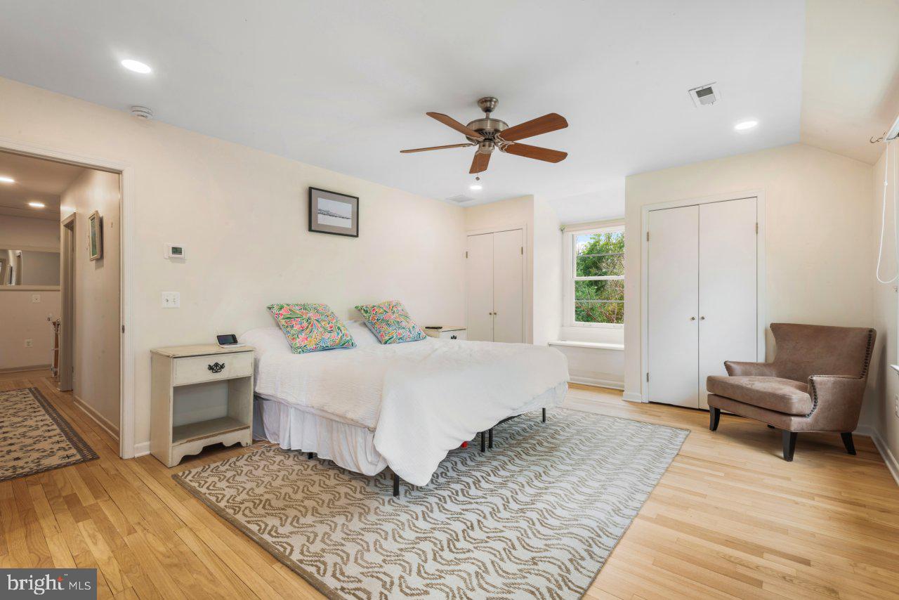 1803 Thornton Ridge Road Baltimore, MD 21204 - Photo 37 of 81 a spacious bedroom with a bed a couch and a window
