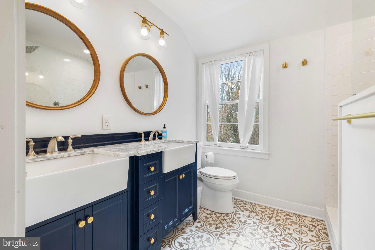 1803 Thornton Ridge Road Baltimore, MD 21204 - Photo 43 of 81 a bathroom with a double vanity sink mirror and toilet