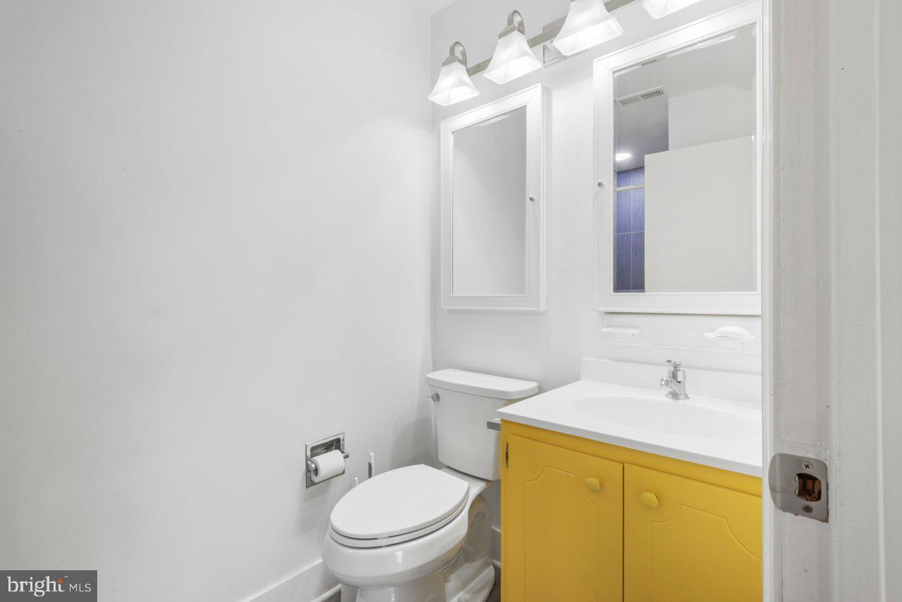 1803 Thornton Ridge Road Baltimore, MD 21204 - Photo 58 of 81 a bathroom with a sink a toilet and a mirror