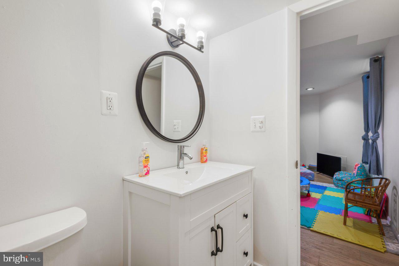 1803 Thornton Ridge Road Baltimore, MD 21204 - Photo 71 of 81 a bathroom with a sink mirror and toilet