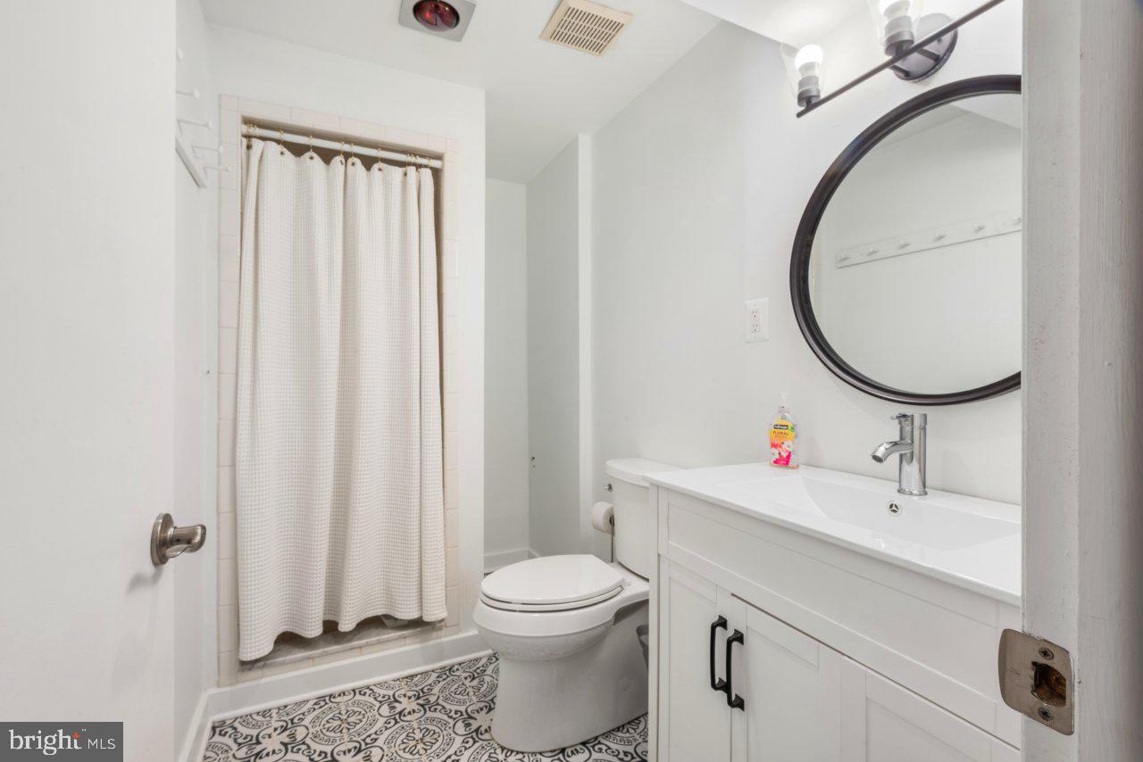 1803 Thornton Ridge Road Baltimore, MD 21204 - Photo 72 of 81 a bathroom with a sink a toilet and a mirror