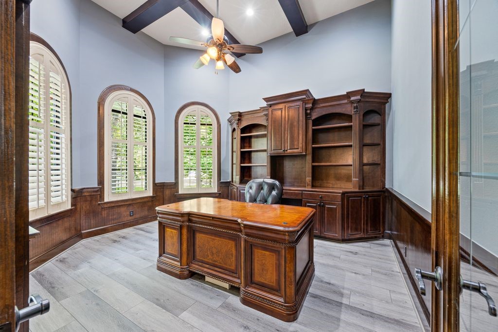 27722 Tiverton Court Spring, TX 77386 - Photo 6 of 33 A distinguished workspace featuring ornate millwork and elegant plantation shutters, this room offers the perfect setting for productive mornings, quiet reading, or creative inspiration while adding character and prestige to the home's main level.