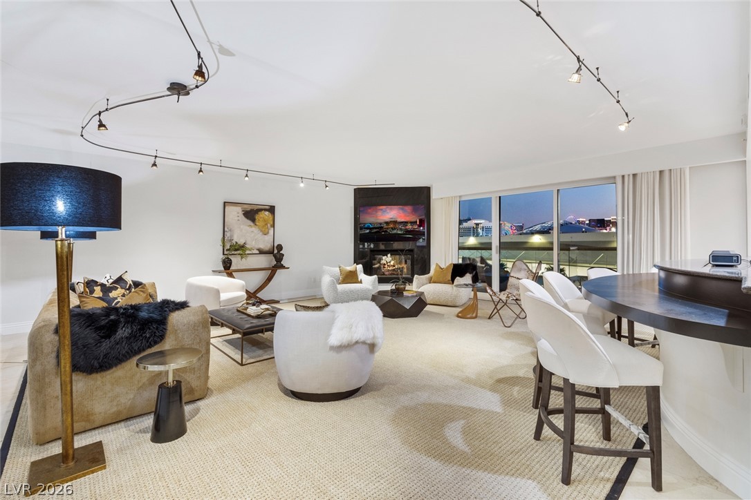 2857 Paradise Road, Unit 602 Las Vegas, NV 89109 - Photo 3 of 33 Sliding glass doors open to city views from this airy open concept living space.
