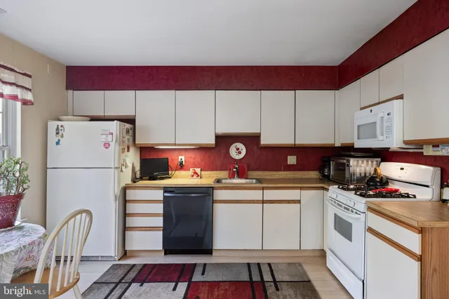 a kitchen with a white stove top oven and refrigerator