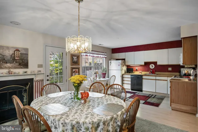 a dining room with furniture a chandelier and window
