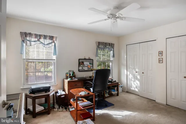 a livingroom with workspace and a window