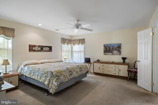 a bedroom with two beds and window