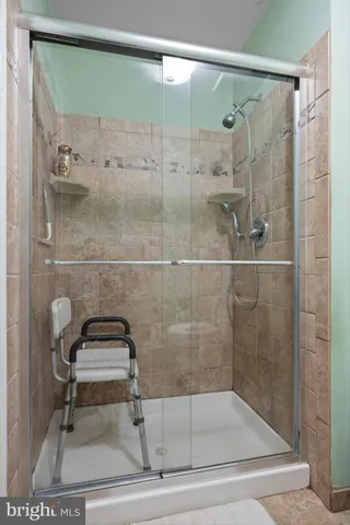 a bathroom with a shower and mirror