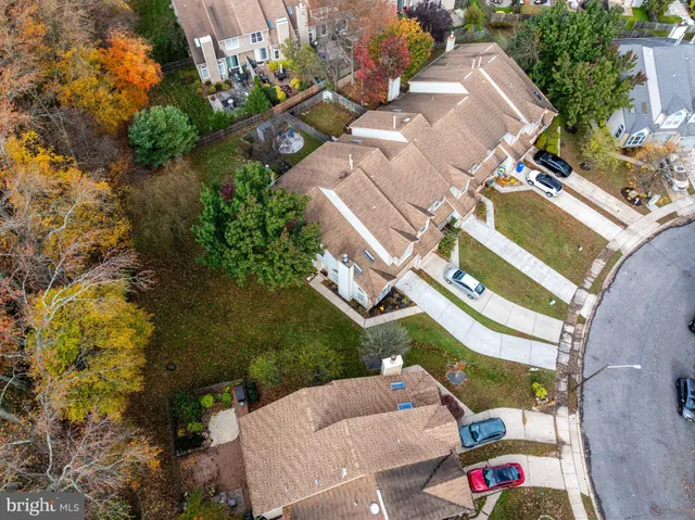 an aerial view of a house with a garden and trees