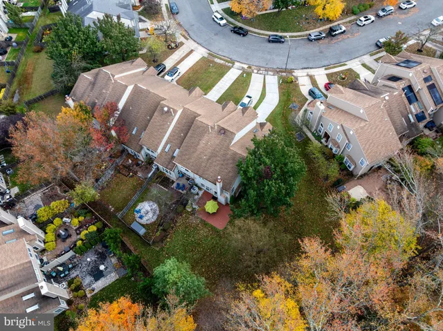 an aerial view of a house with garden space and street view