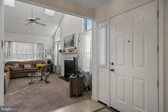 a living room with furniture a fireplace and a window