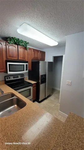 a kitchen with stainless steel appliances a refrigerator and a stove
