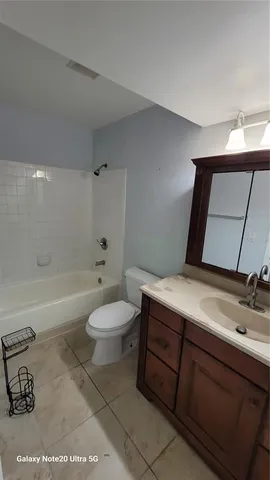 a bathroom with a sink a toilet and bathtub