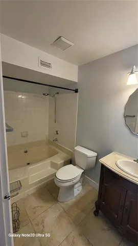 a bathroom with a toilet a sink and shower