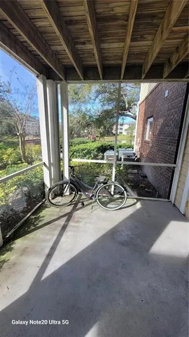 a view of a porch with furniture and front door