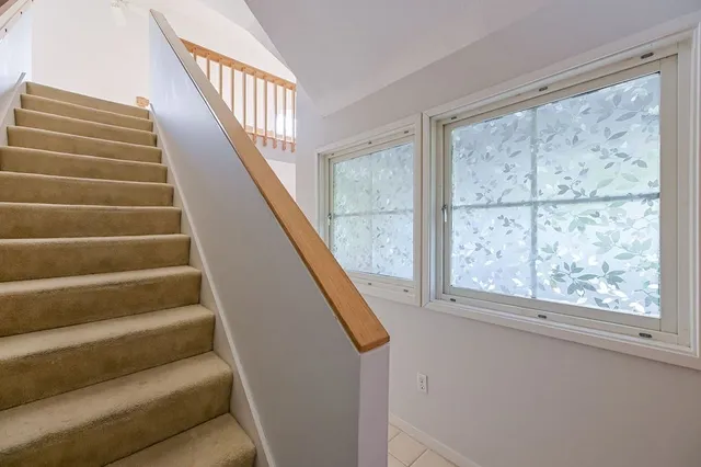 a view of staircase with white walls and windows