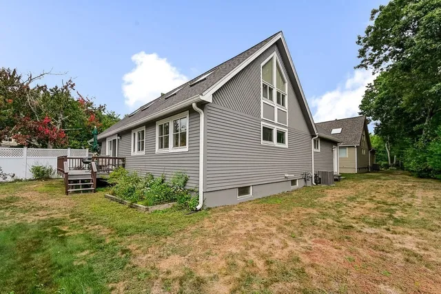 a view of deck with table and chairs with wooden floor and plants