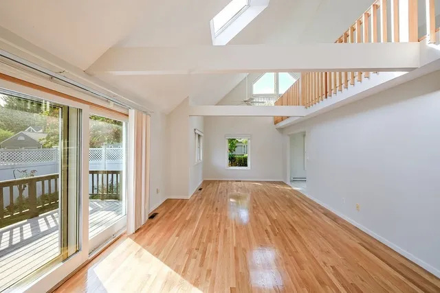 a view of hallway with wooden floor and door
