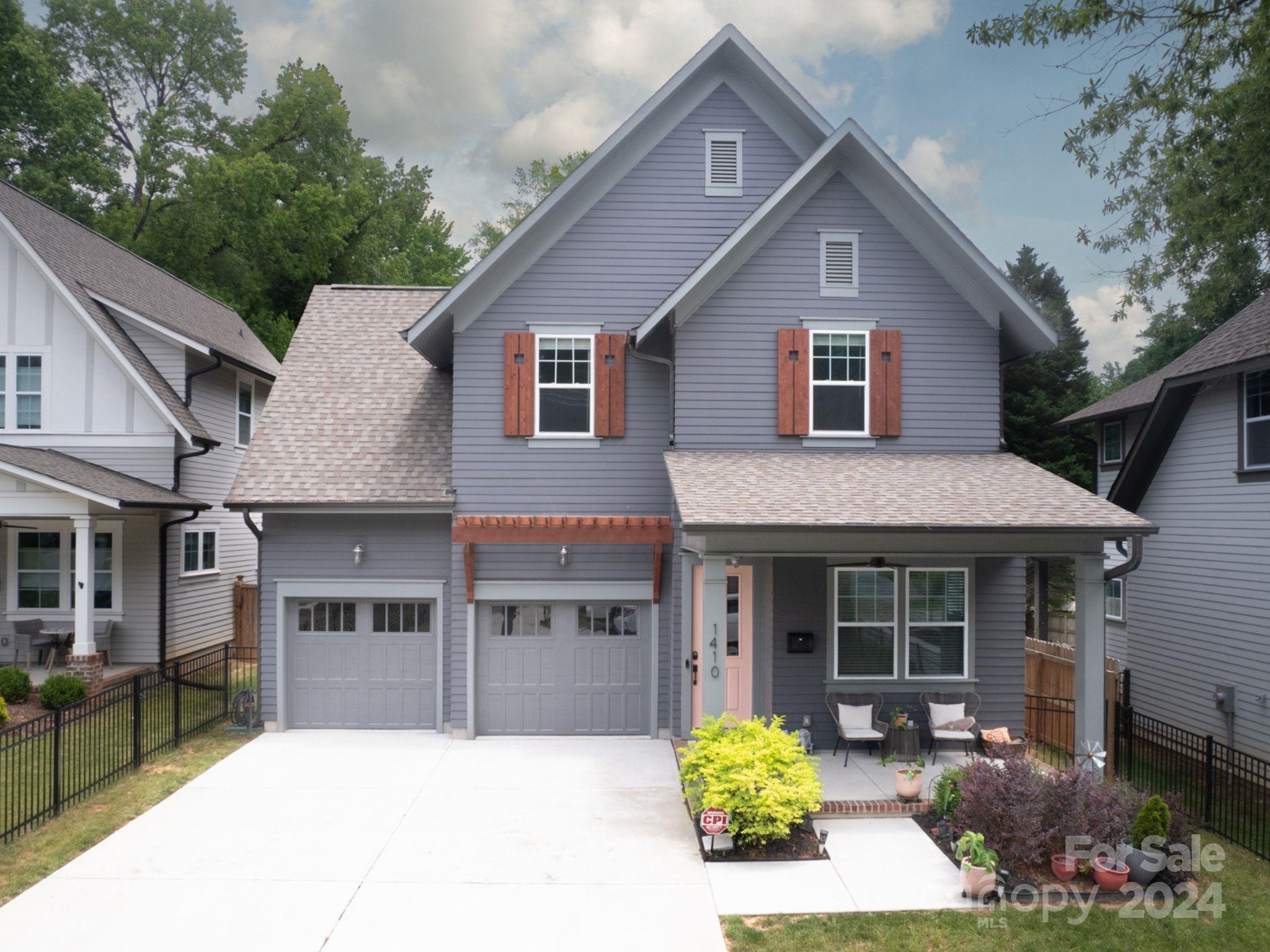 1410 Briar Creek Road Charlotte, NC 28205 - Photo 1 of 42 a front view of a house with a garden and porch