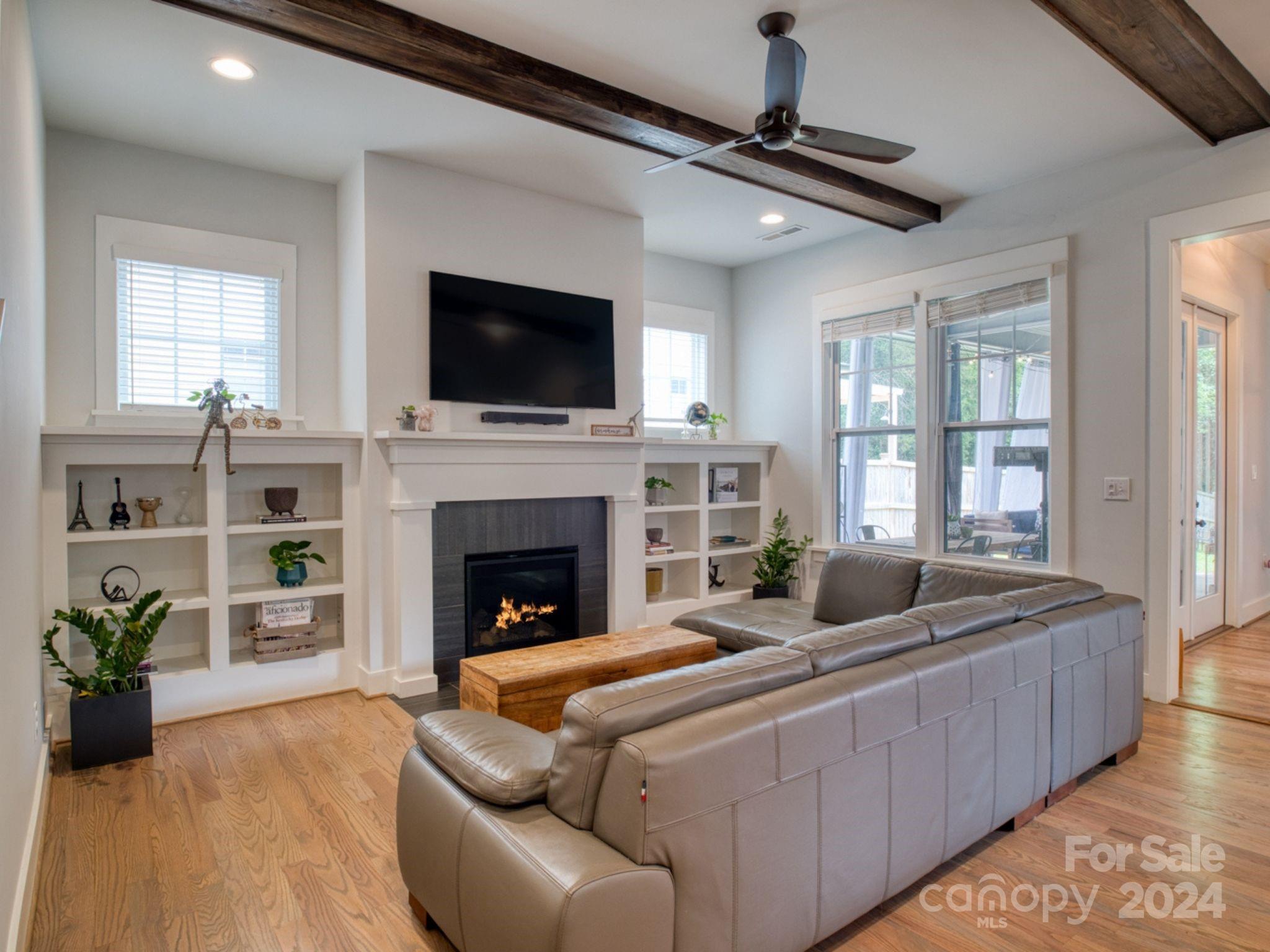 1410 Briar Creek Road Charlotte, NC 28205 - Photo 11 of 42 a living room with furniture fireplace and flat screen tv