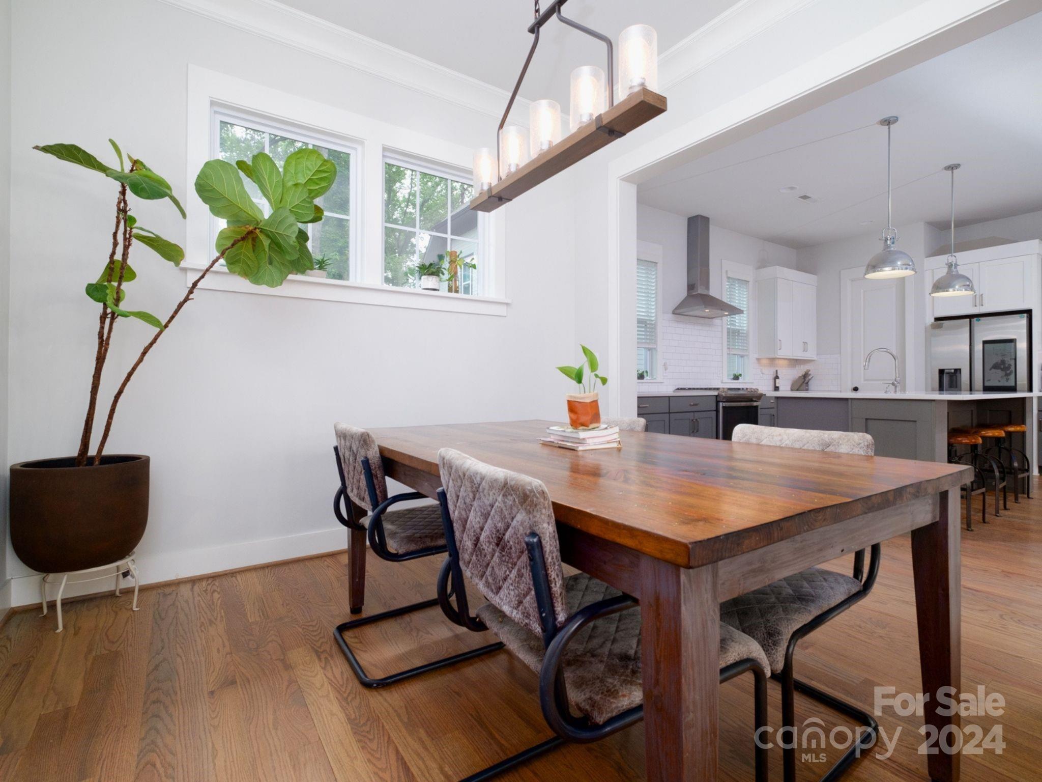 1410 Briar Creek Road Charlotte, NC 28205 - Photo 18 of 42 a view of a dining room with furniture and a potted plant