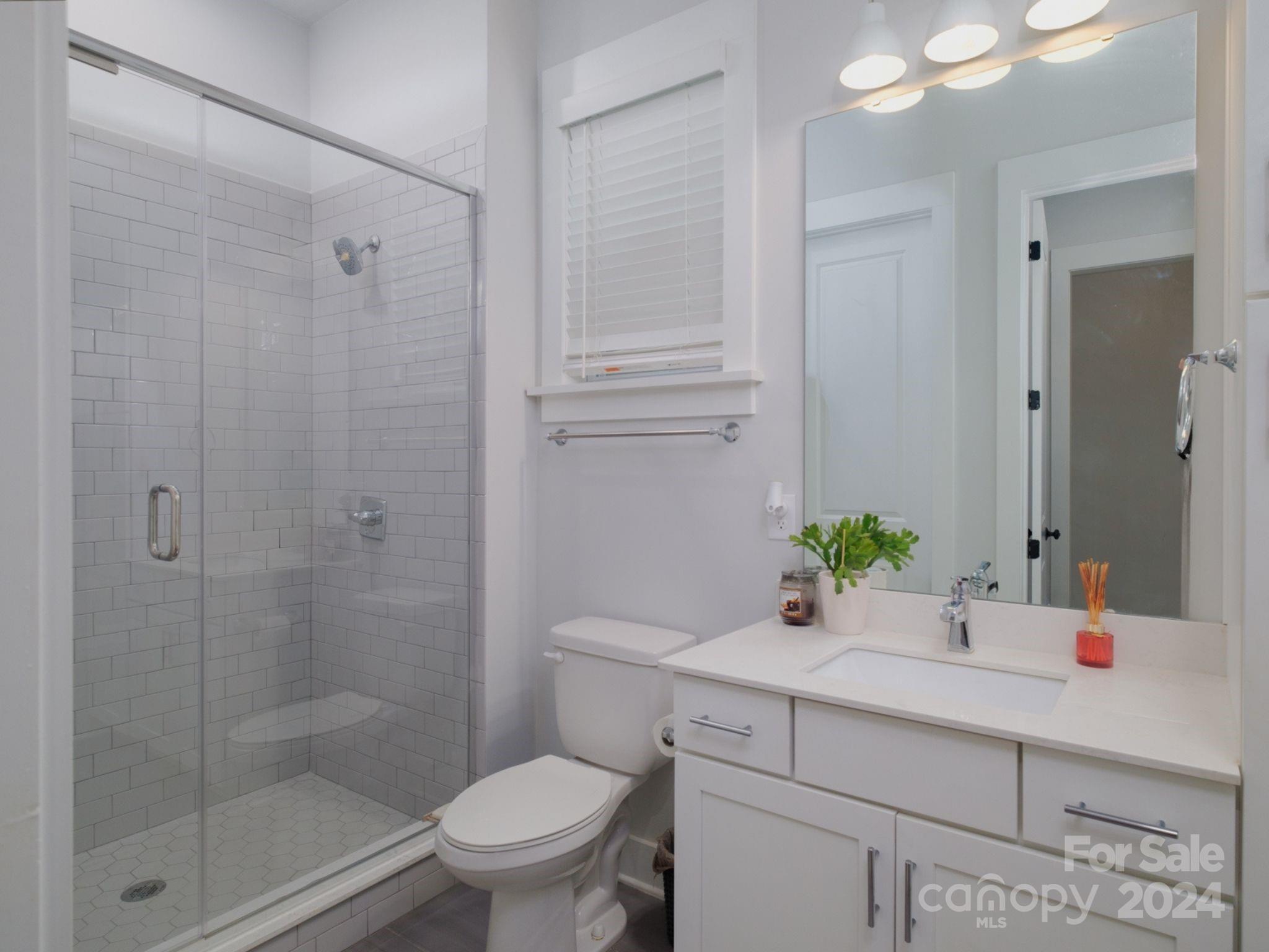 1410 Briar Creek Road Charlotte, NC 28205 - Photo 21 of 42 a bathroom with a sink vanity granite toilet and shower