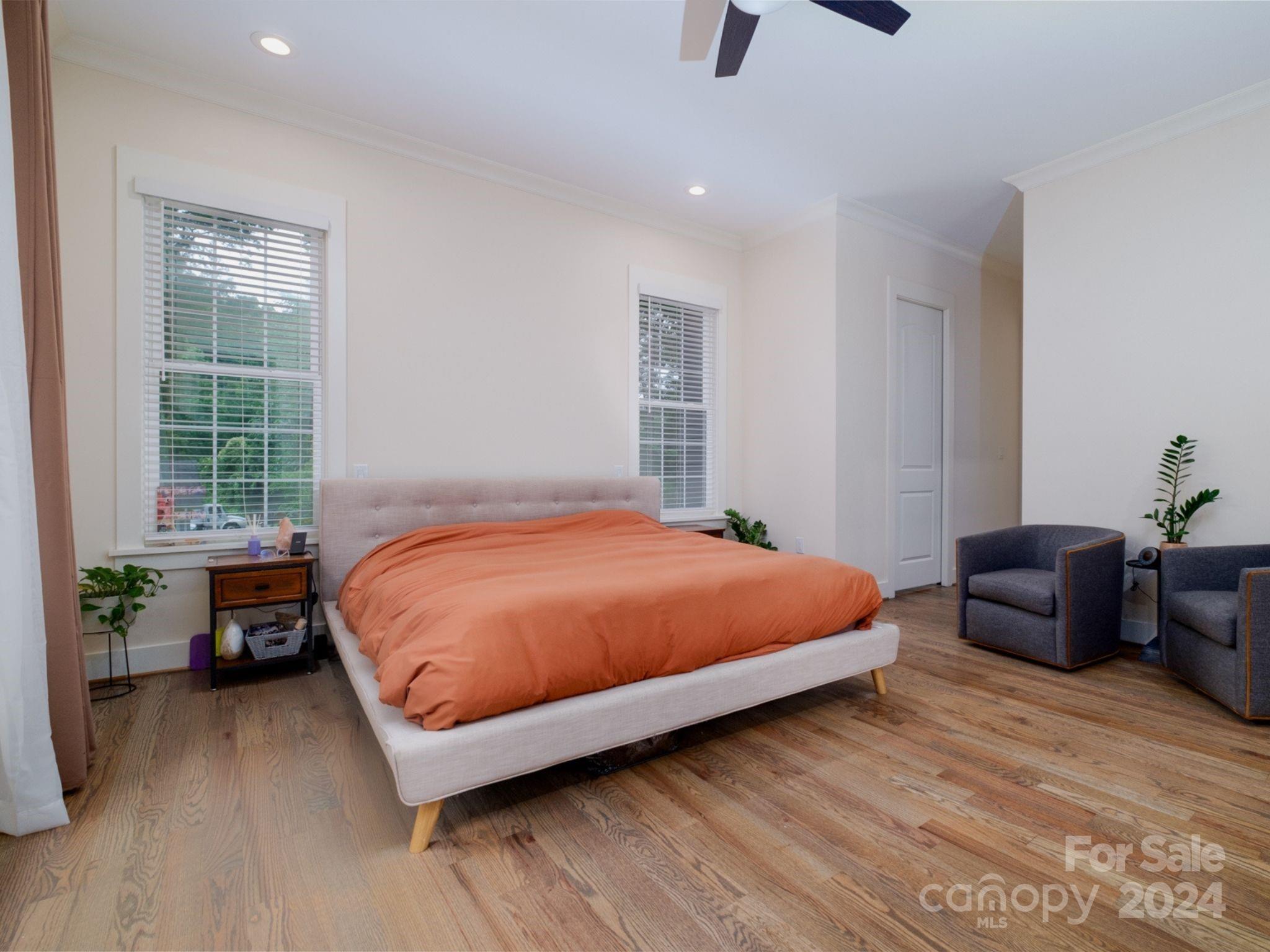 1410 Briar Creek Road Charlotte, NC 28205 - Photo 24 of 42 a bedroom with a bed and a chair