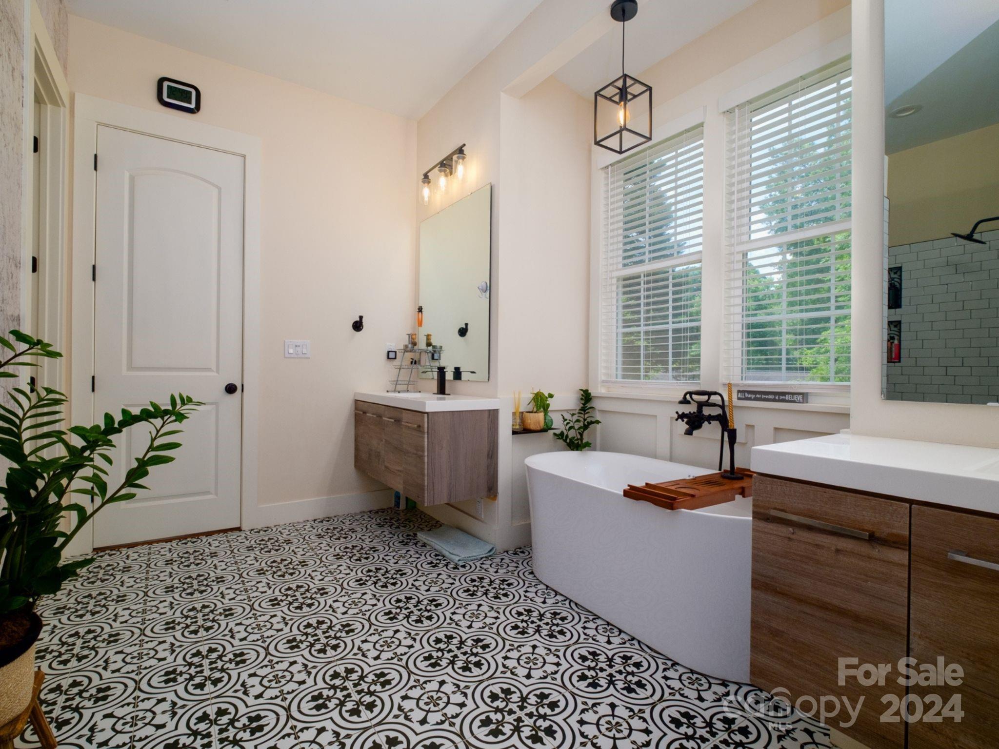 1410 Briar Creek Road Charlotte, NC 28205 - Photo 28 of 42 a spacious bathroom with a tub sink and mirror