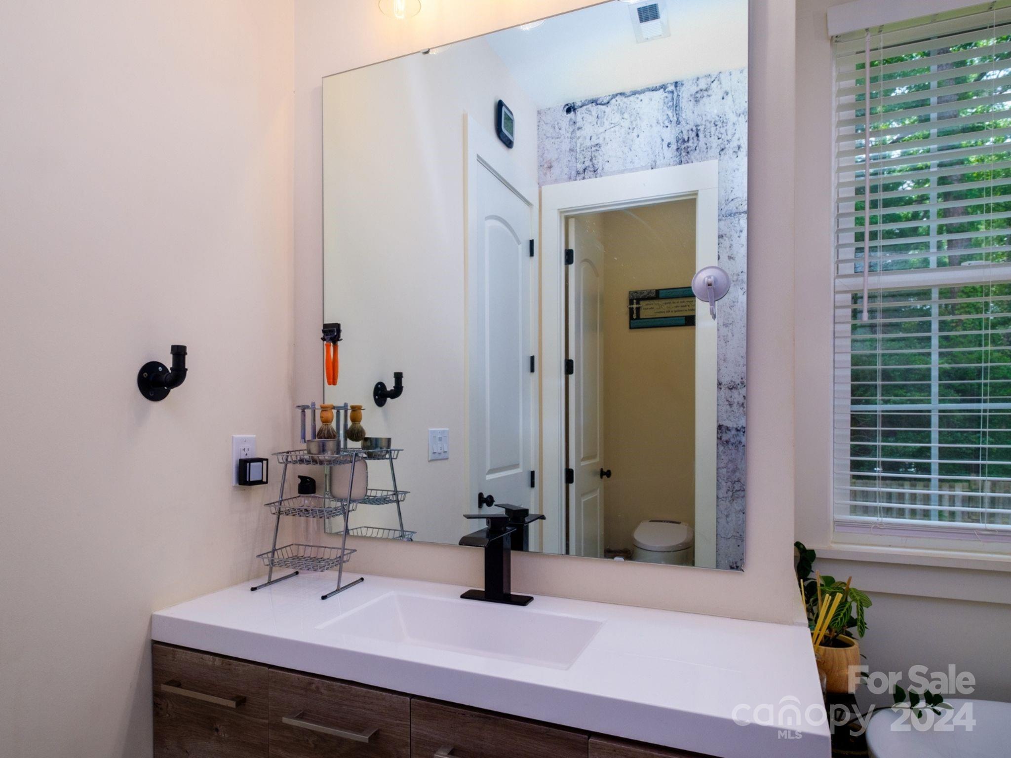 1410 Briar Creek Road Charlotte, NC 28205 - Photo 29 of 42 a bathroom with a sink and a mirror