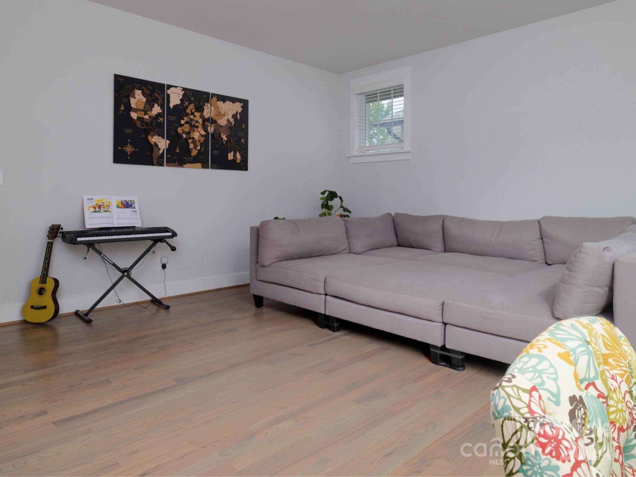 1410 Briar Creek Road Charlotte, NC 28205 - Photo 32 of 42 a living room with couches and a painting on the wall