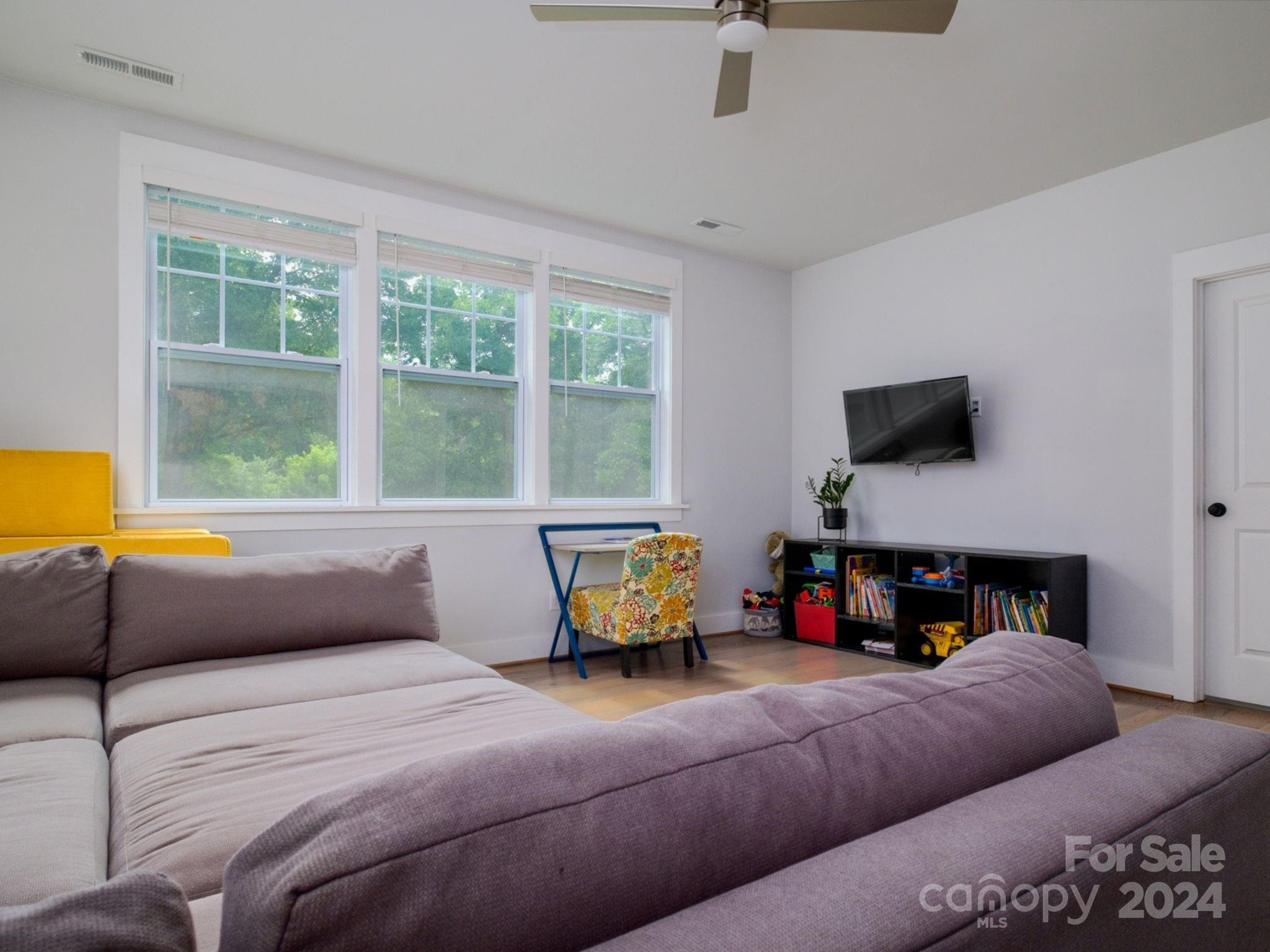 1410 Briar Creek Road Charlotte, NC 28205 - Photo 35 of 42 a bedroom with a bed and large windows