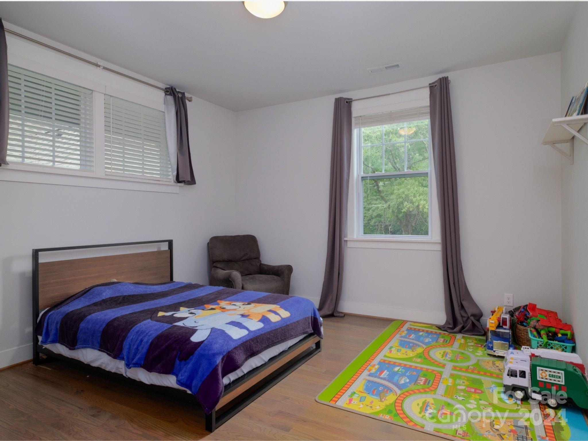 1410 Briar Creek Road Charlotte, NC 28205 - Photo 37 of 42 a bedroom with a bed and a window