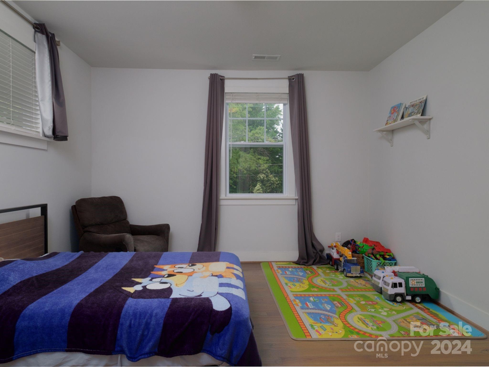 1410 Briar Creek Road Charlotte, NC 28205 - Photo 38 of 42 a bedroom with a bed and window