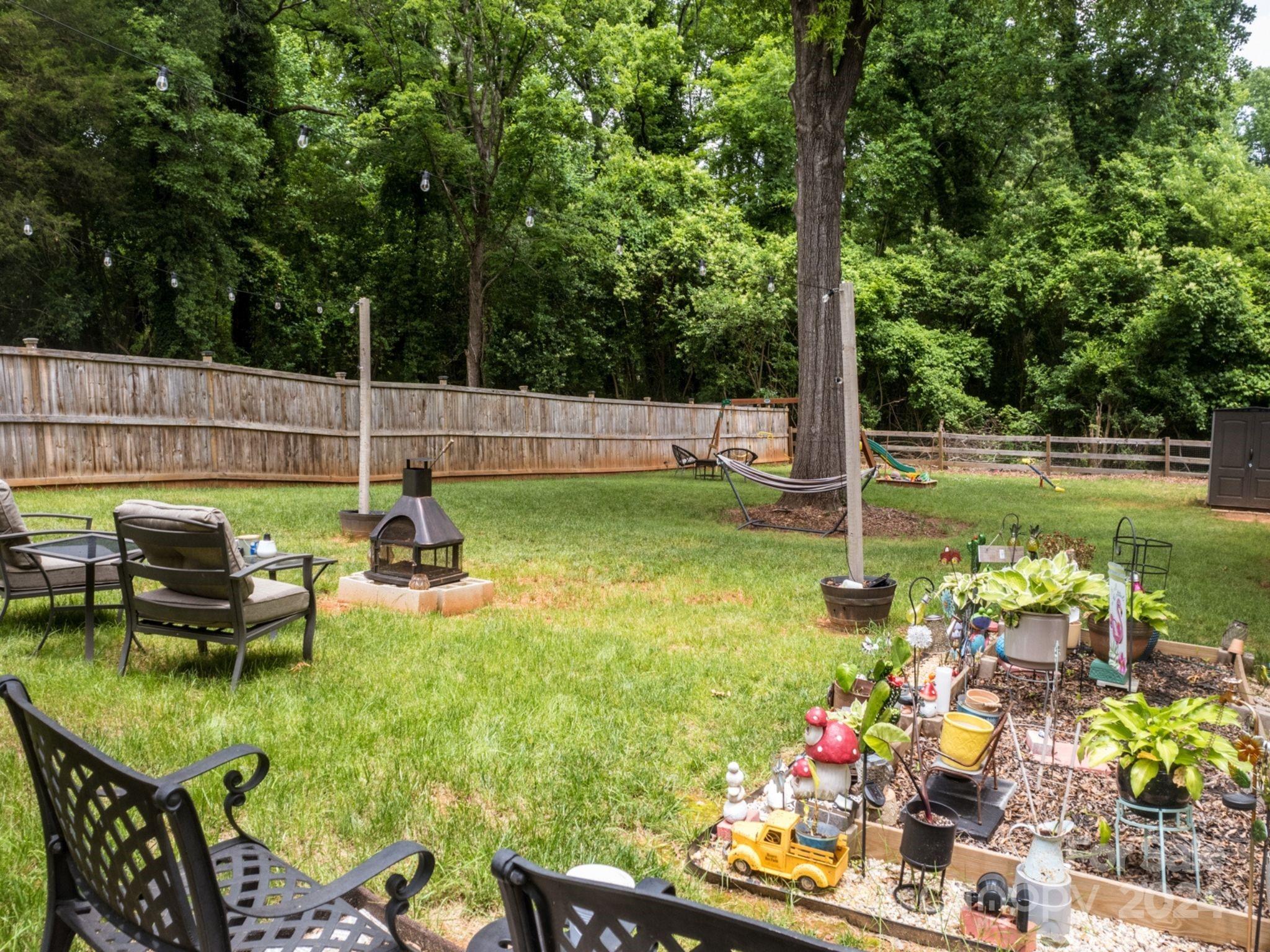 1410 Briar Creek Road Charlotte, NC 28205 - Photo 4 of 42 a view of a swimming pool with a patio and a garden
