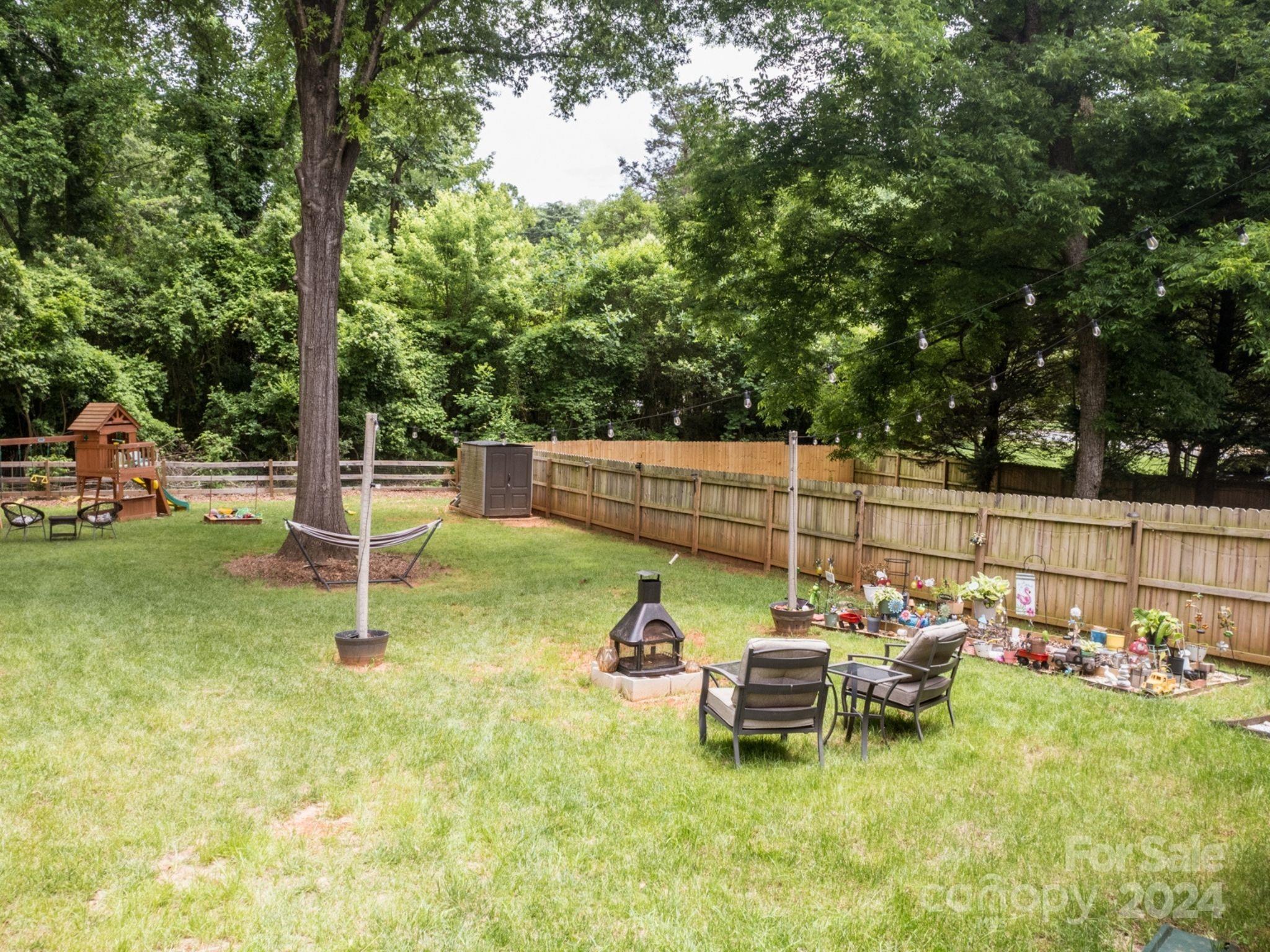 1410 Briar Creek Road Charlotte, NC 28205 - Photo 5 of 42 a view of a chair and tables in the back yard