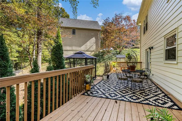 a view of a wooden deck with a table and chairs