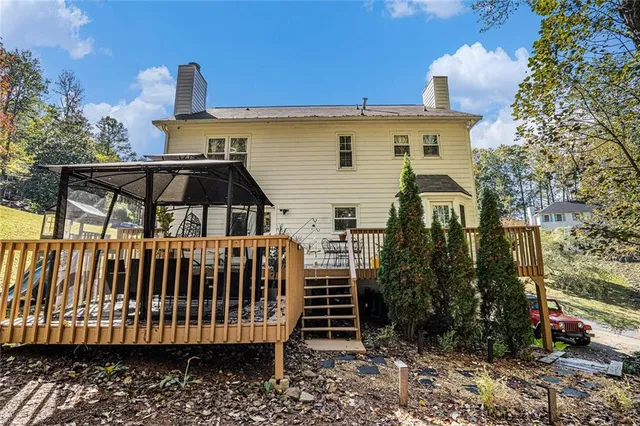 a view of a house with backyard and sitting area