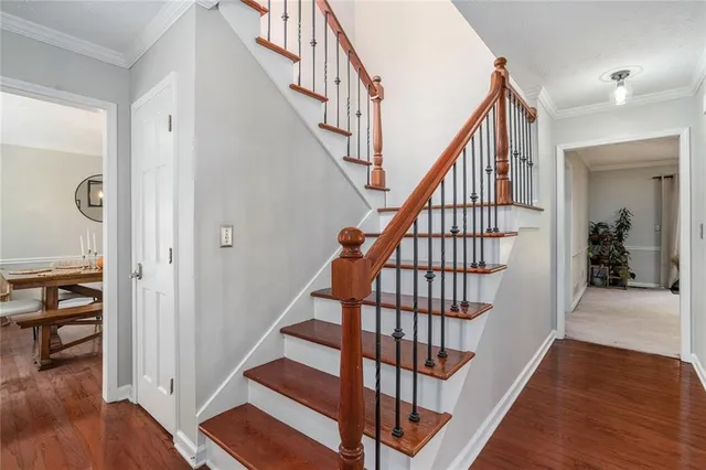 a view of staircase with wooden floor and a rug