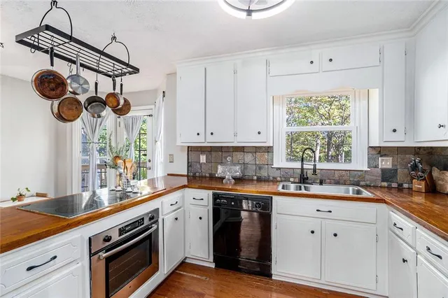 a kitchen with a sink cabinets and window