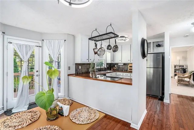 a kitchen with stainless steel appliances granite countertop a refrigerator and a stove