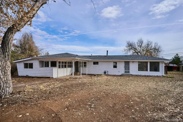 a house that has a tree in front of it