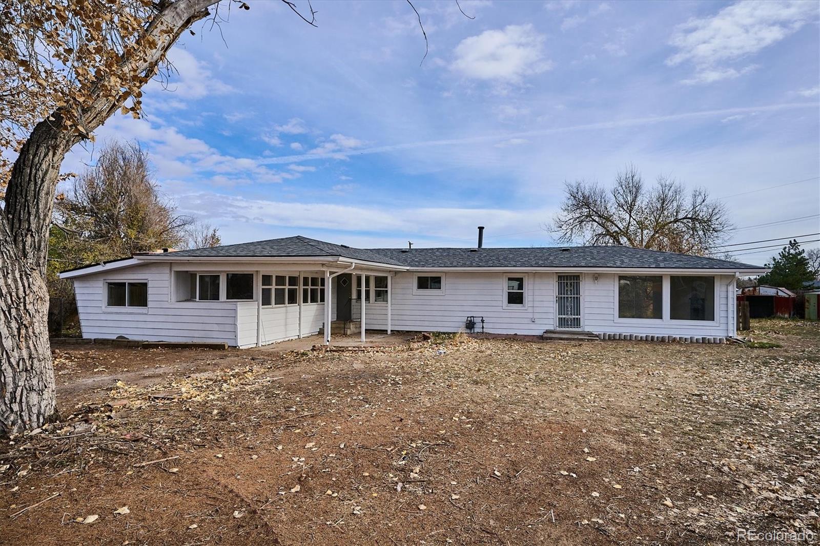 2110 Eagle Circle Aurora, CO 80011 - Photo 2 of 8 a house that has a tree in front of it