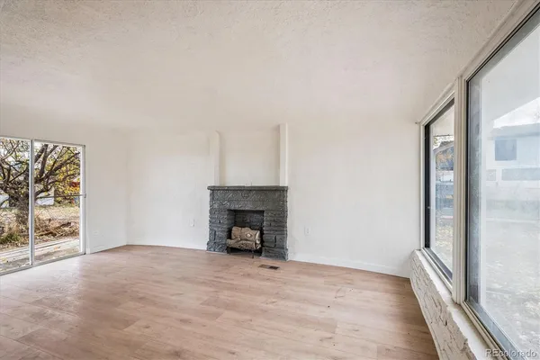 a view of empty room with fireplace and fan