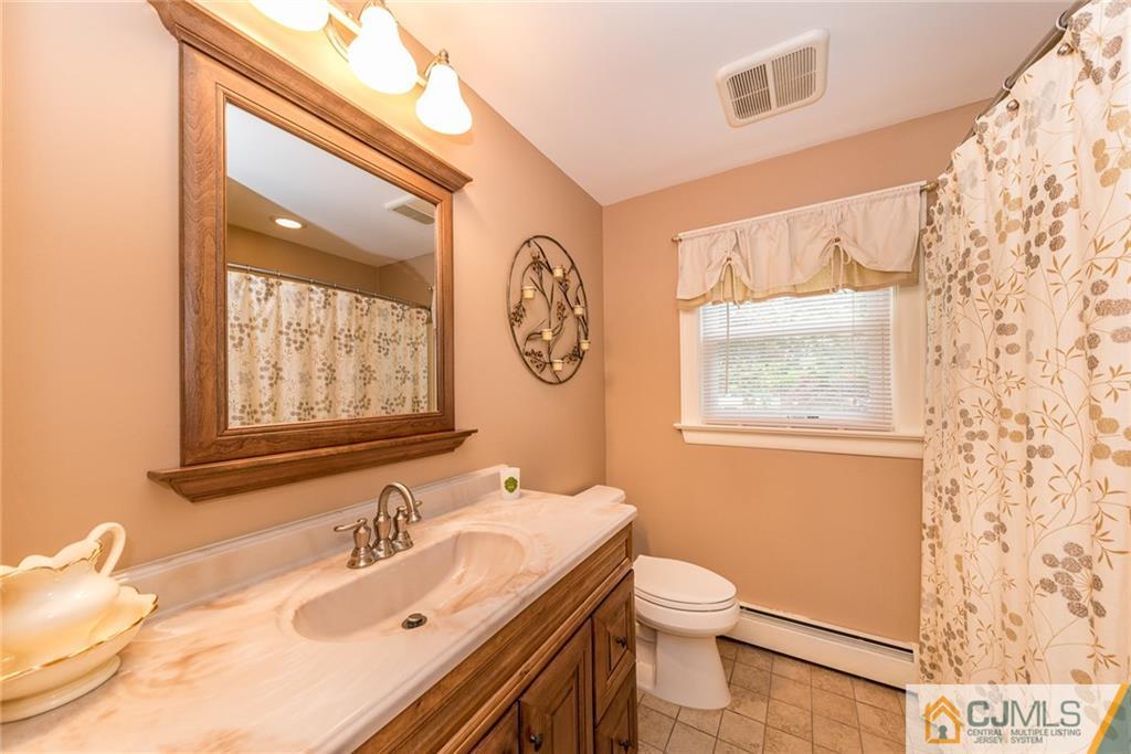 144 Upper Ferry Road Ewing, NJ 08628 - Photo 12 of 25 a bathroom with a granite countertop toilet a sink and a mirror