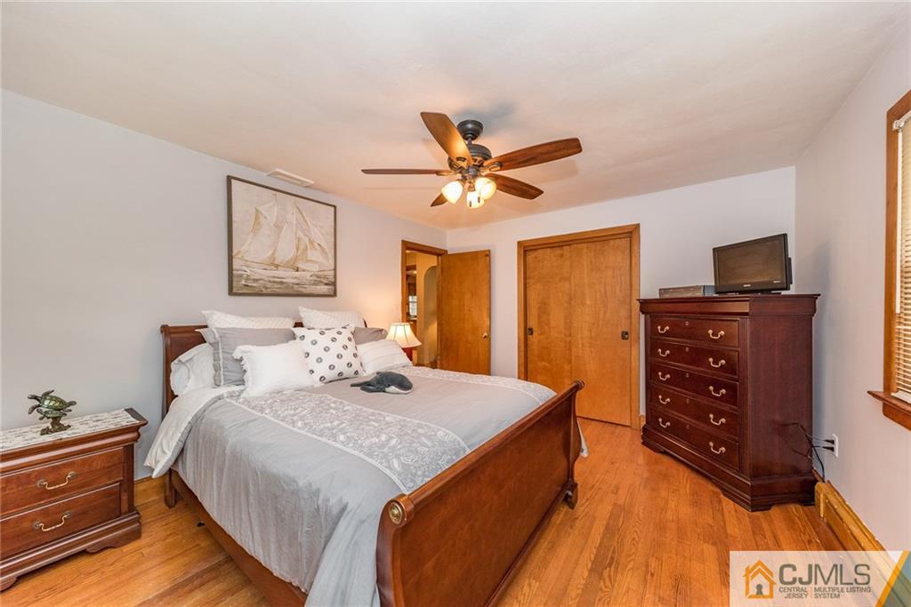 144 Upper Ferry Road Ewing, NJ 08628 - Photo 13 of 25 a bedroom with a bed and a flat tv screen on dresser