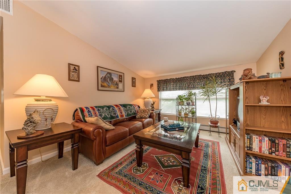 144 Upper Ferry Road Ewing, NJ 08628 - Photo 15 of 25 a living room with furniture and a book shelf