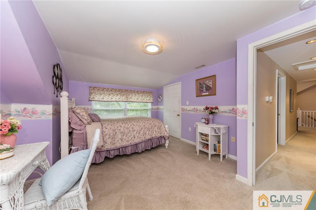 144 Upper Ferry Road Ewing, NJ 08628 - Photo 19 of 25 a bedroom with a bed and a chair