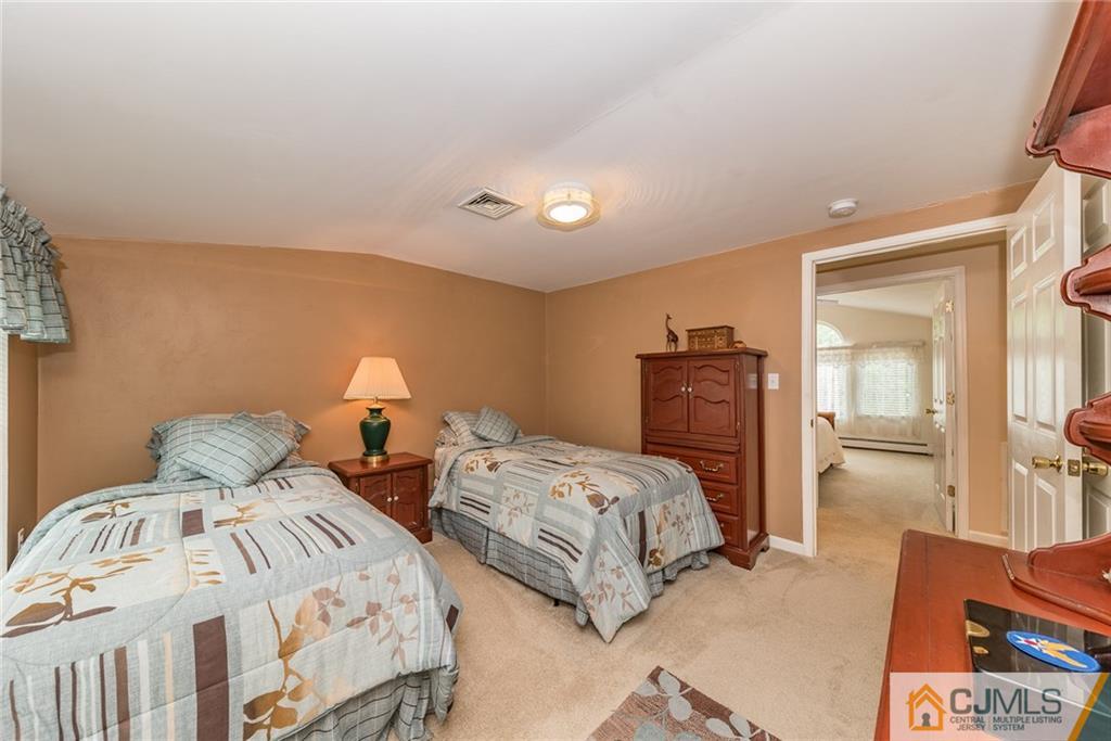 144 Upper Ferry Road Ewing, NJ 08628 - Photo 20 of 25 a bedroom with two beds and painting on the wall