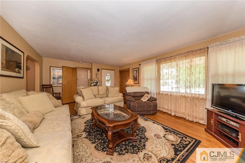 144 Upper Ferry Road Ewing, NJ 08628 - Photo 3 of 25 a living room with furniture and a flat screen tv